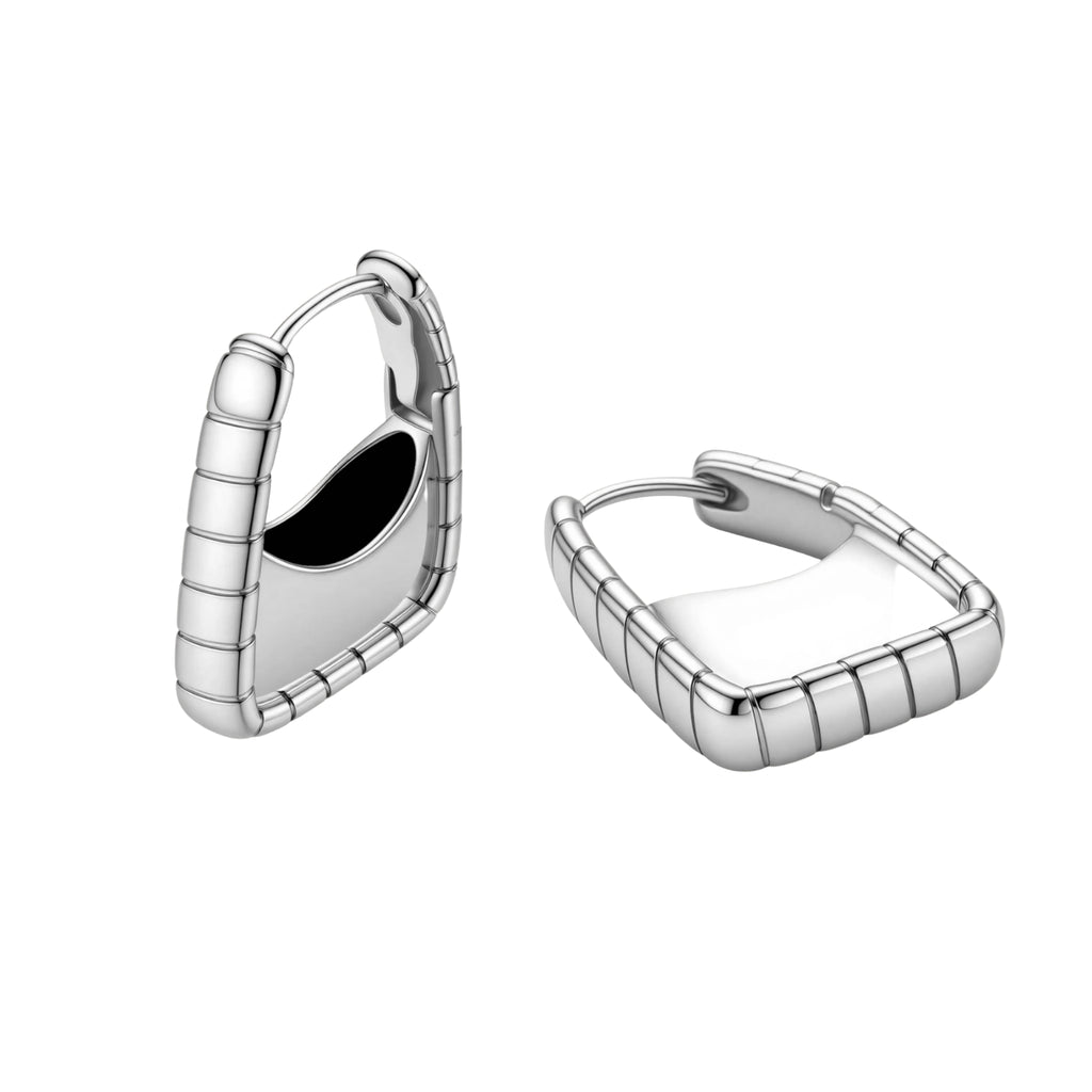 Close-up of platinum-plated sterling silver hoop earrings with horizontal textured grooves on white background.