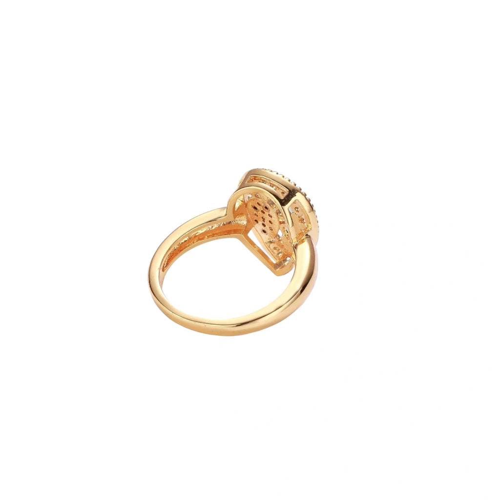 Teardrop-shaped gold-plated ring with turquoise enamel flowers and crystal pavé detail on cream background