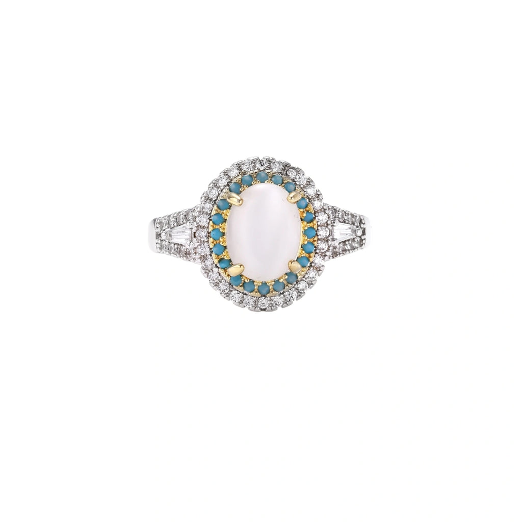 Vintage-style cocktail ring with luminous cat's eye center stone surrounded by turquoise and crystal double halo on white gold plated band