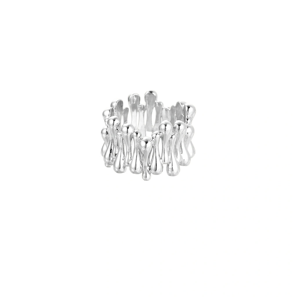 Wide band ring with sculptural wave ripples in polished white gold plated eco-brass on cream background