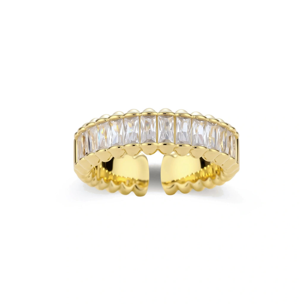 Adjustable gold-plated ring with rectangular cubic zirconia stones in eternity band style on neutral background.