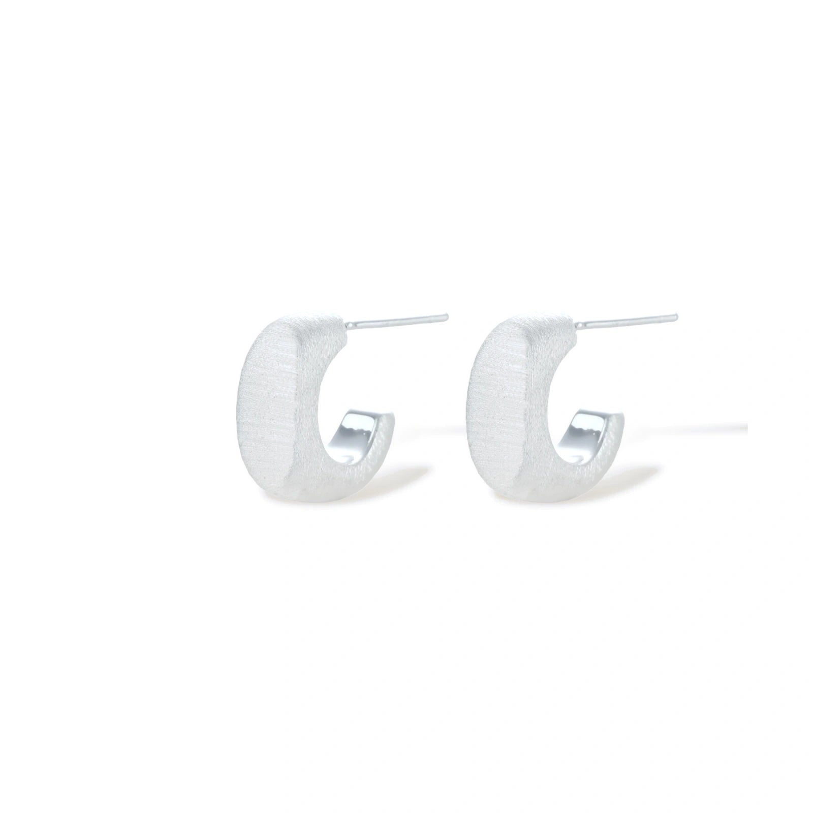 Pair of small silver-plated huggie hoop earrings with clean minimal design on neutral background.
