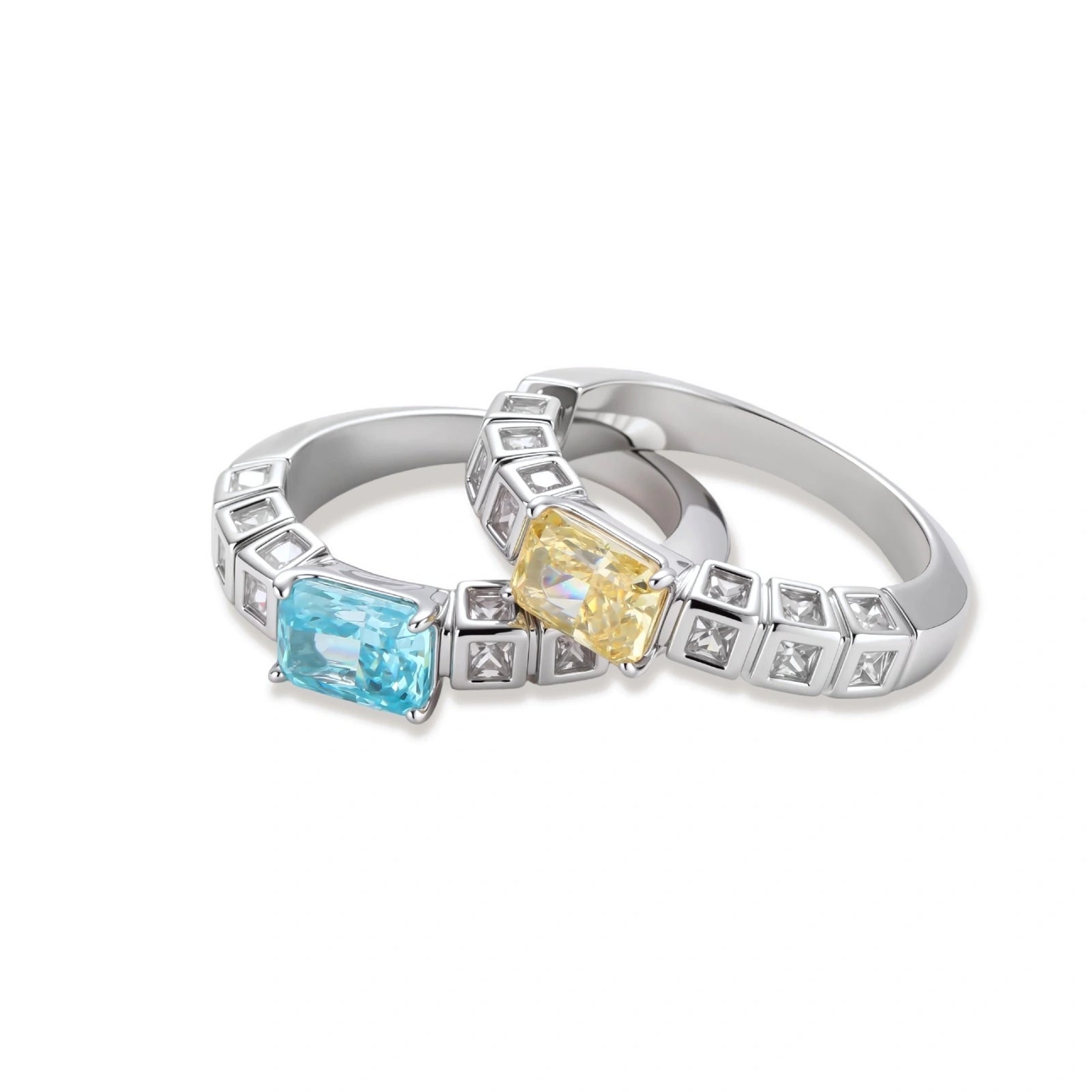 Adjustable ring with emerald-cut yellow zirconia center and clear accent stones in geometric platinum-plated setting